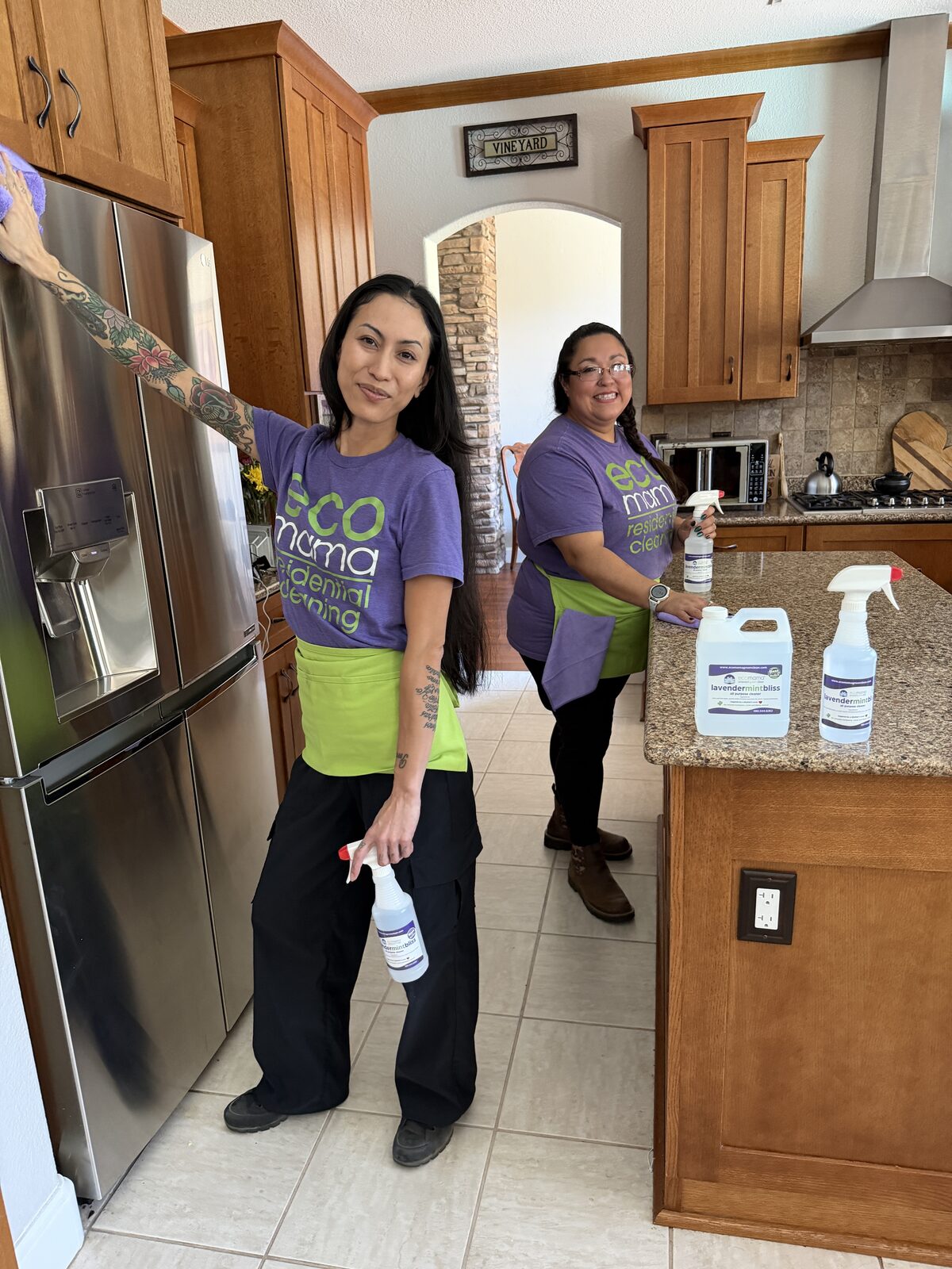 Eco Mama team member cleaning a bright Phoenix living room with eco-friendly products